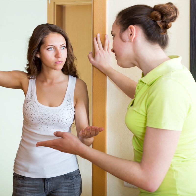 Two women arguing at the door in a neighbour dispute